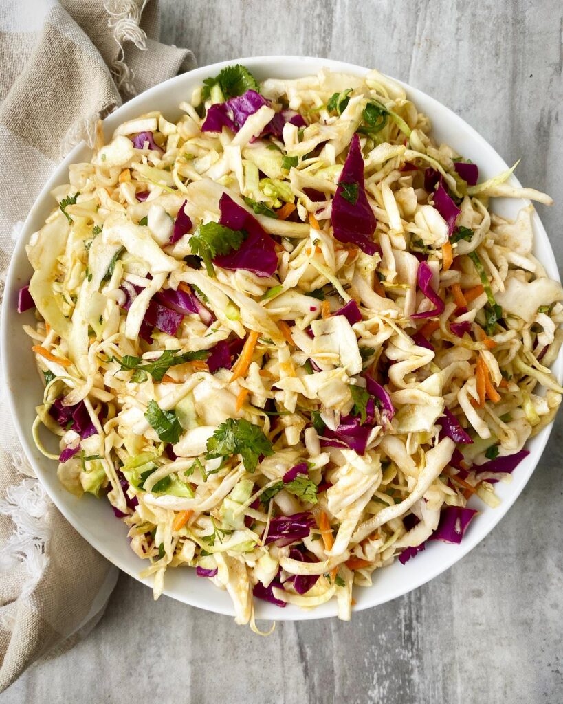 overhead shot of Sweet Spicy Vinegar Based Coleslaw in a white bowl