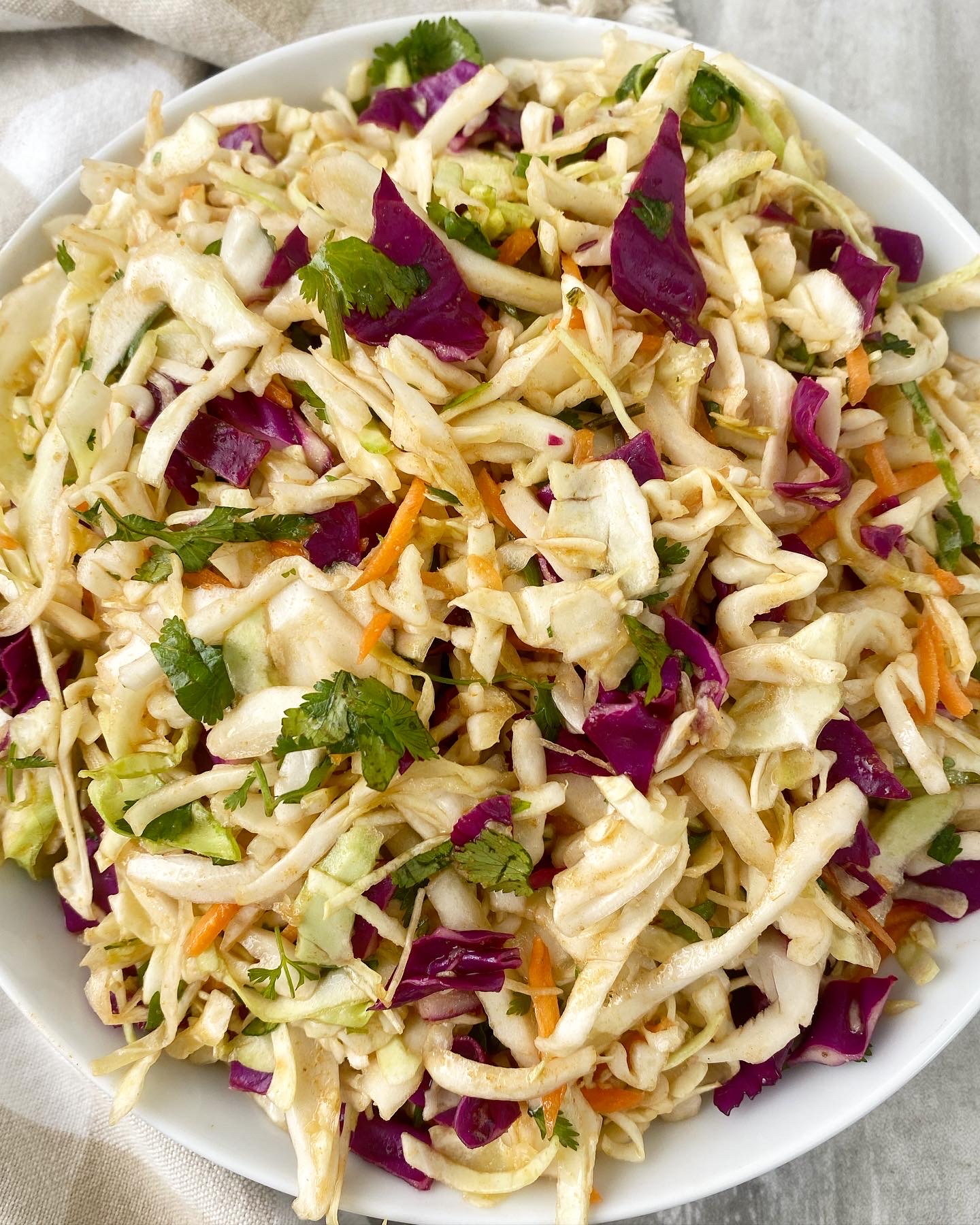 overhead shot of Sweet Spicy Vinegar Based Coleslaw in a white bowl