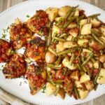 italian chicken dinner on a big white plate
