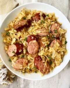 overhead shot of Sausage & Sauerkraut in a white bowl