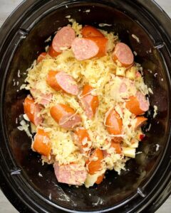 uncooked Slow Cooker Sausage & Sauerkraut in the slow cooker