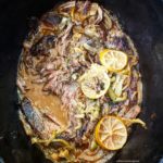overhead shot of cilantro lime beef in a black slow cooker