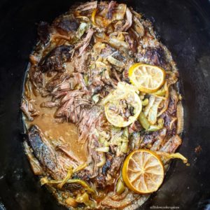overhead shot of cilantro lime beef in a black slow cooker