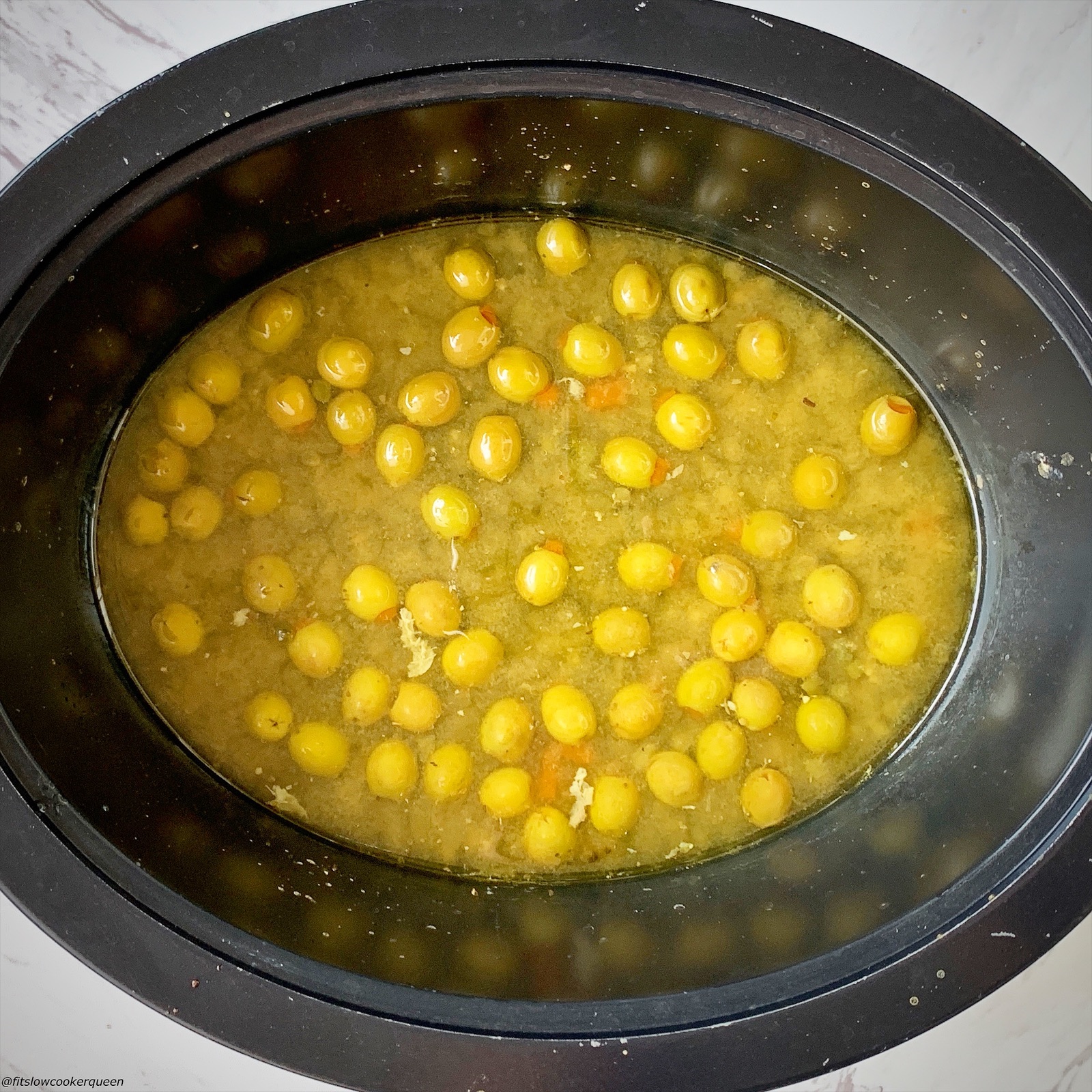 olives, capers and sauce in the slow cooker with chicken removed