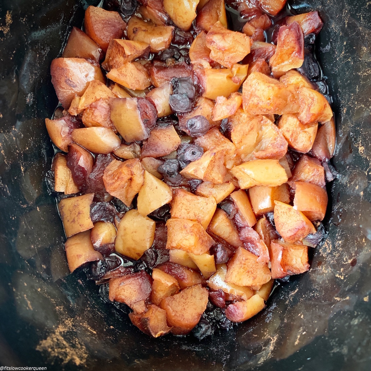 cooked blueberries, apples, cinnamon and water in the slow cooker 
