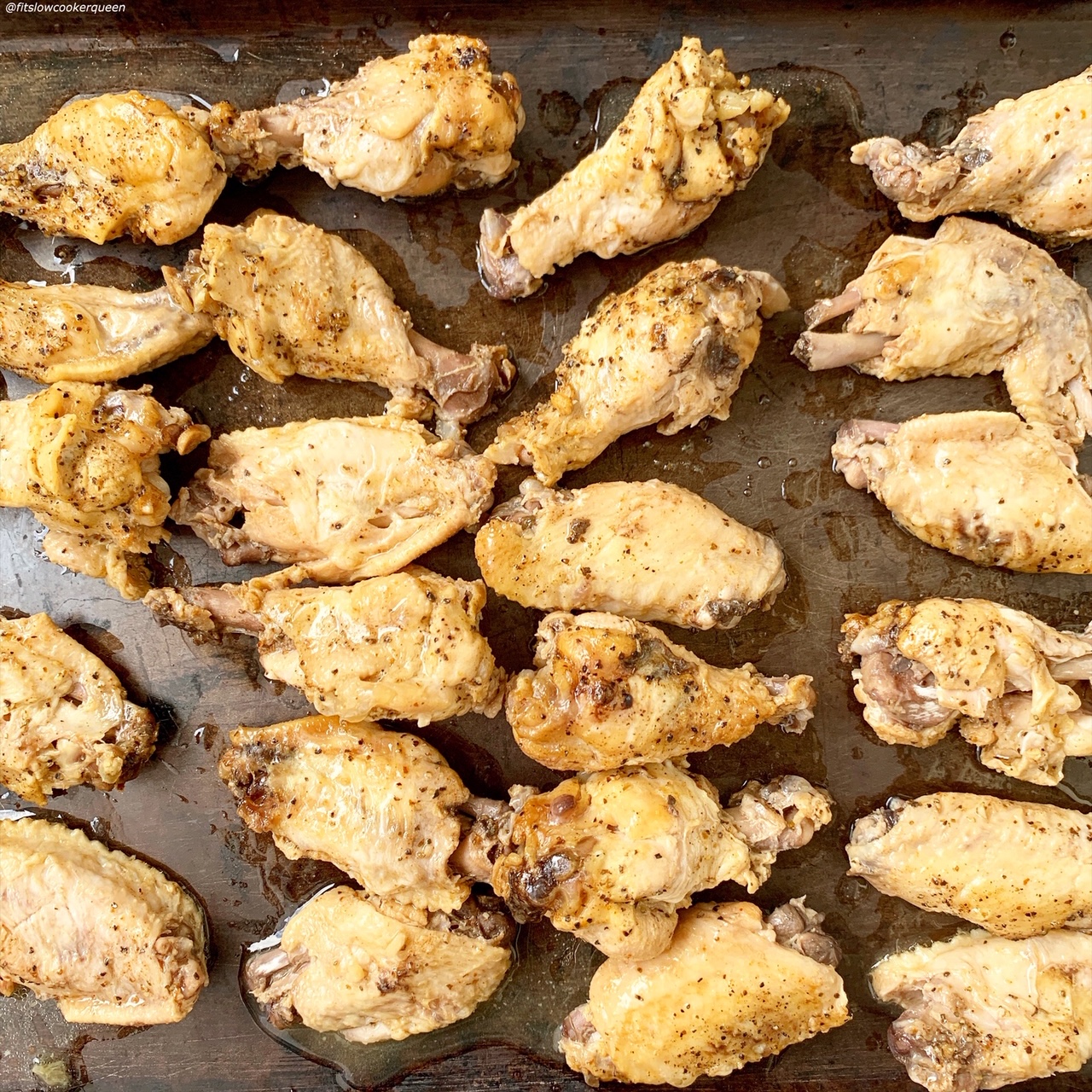 chicken wings lined on a baking sheet for broiling
