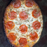 overhead shot of cooked spaghetti squash pizza with pepperoni and sausage