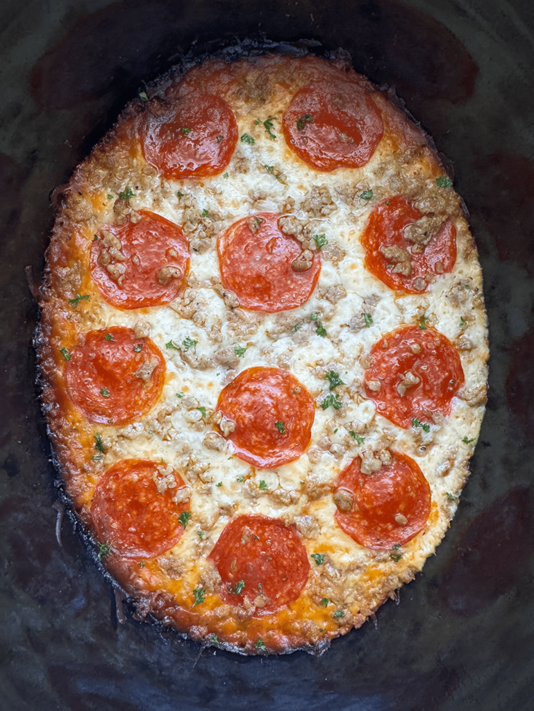 overhead shot of cooked spaghetti squash pizza with pepperoni and sausage