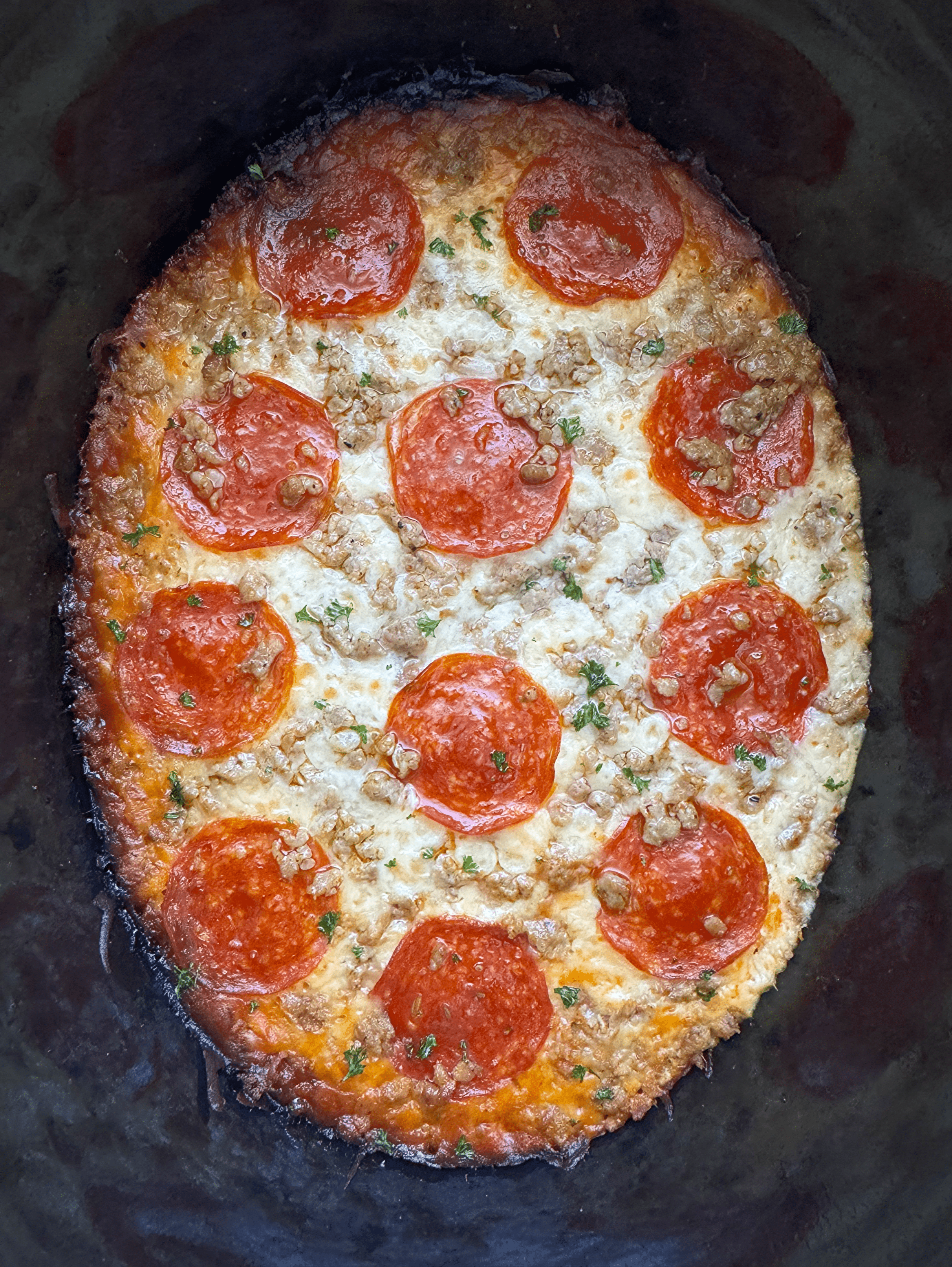 overhead shot of cooked spaghetti squash pizza with pepperoni and sausage 