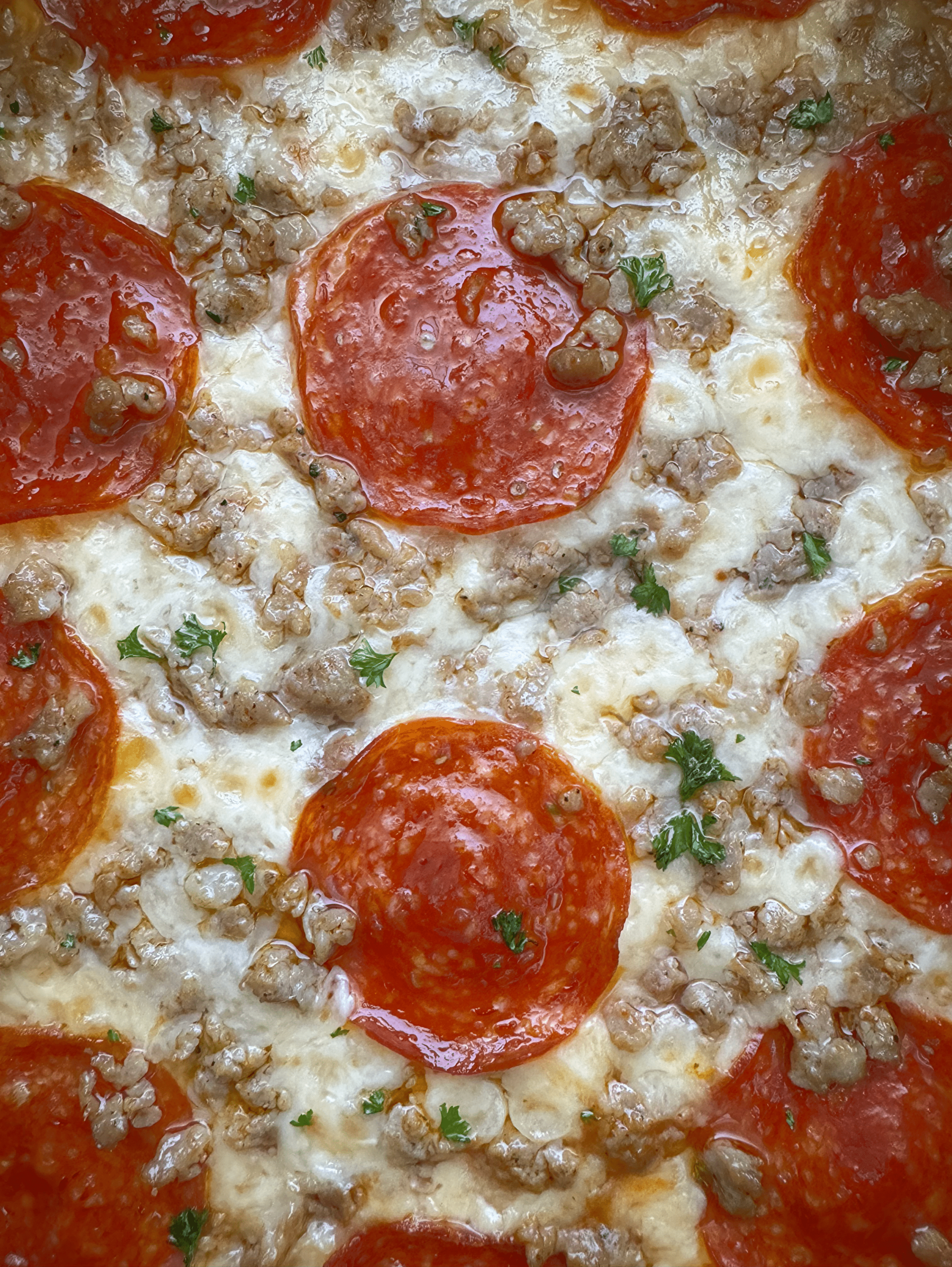 close up shot of cooked spaghetti squash pizza with pepperoni and sausage