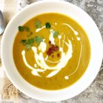 overhead shot of Slow Cooker Butternut Squash Soup in a white bowl