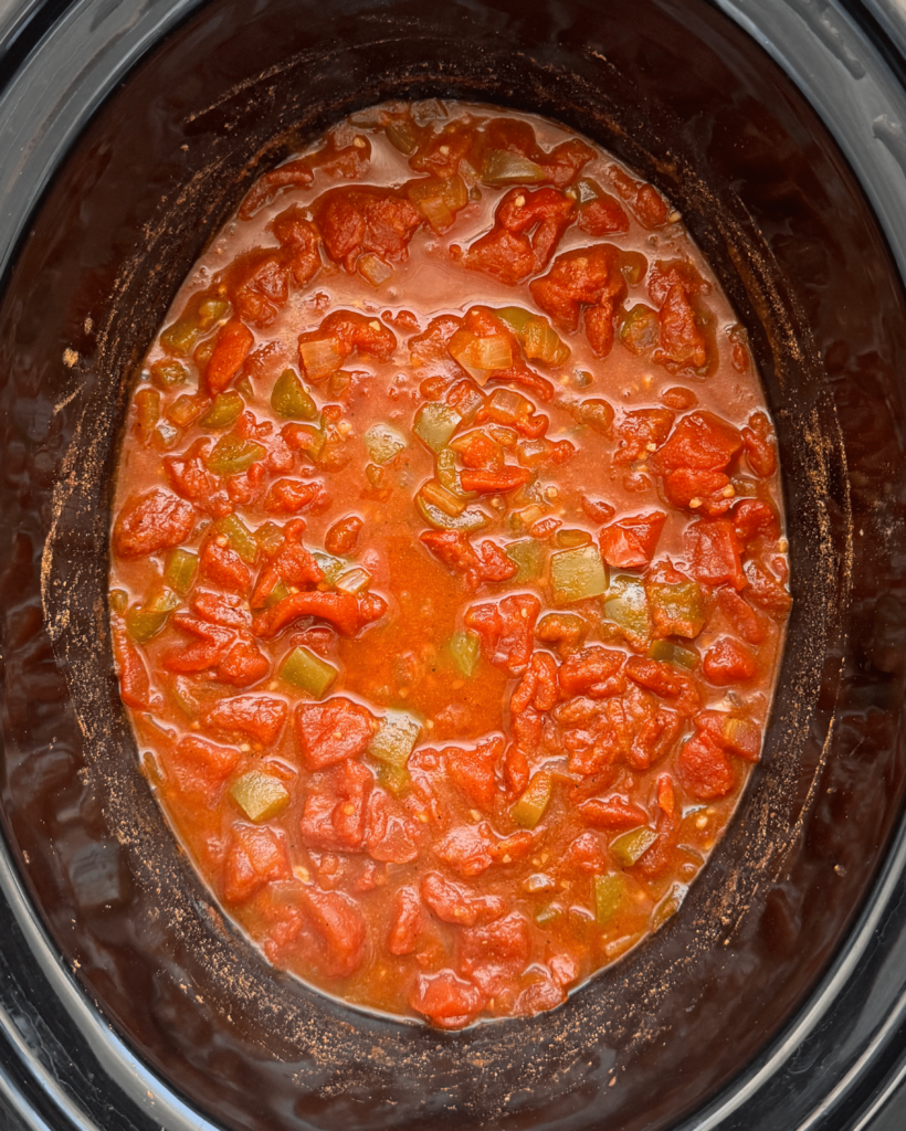 overhead shot of cooked slow cooker shakshuka in a black slow cooker