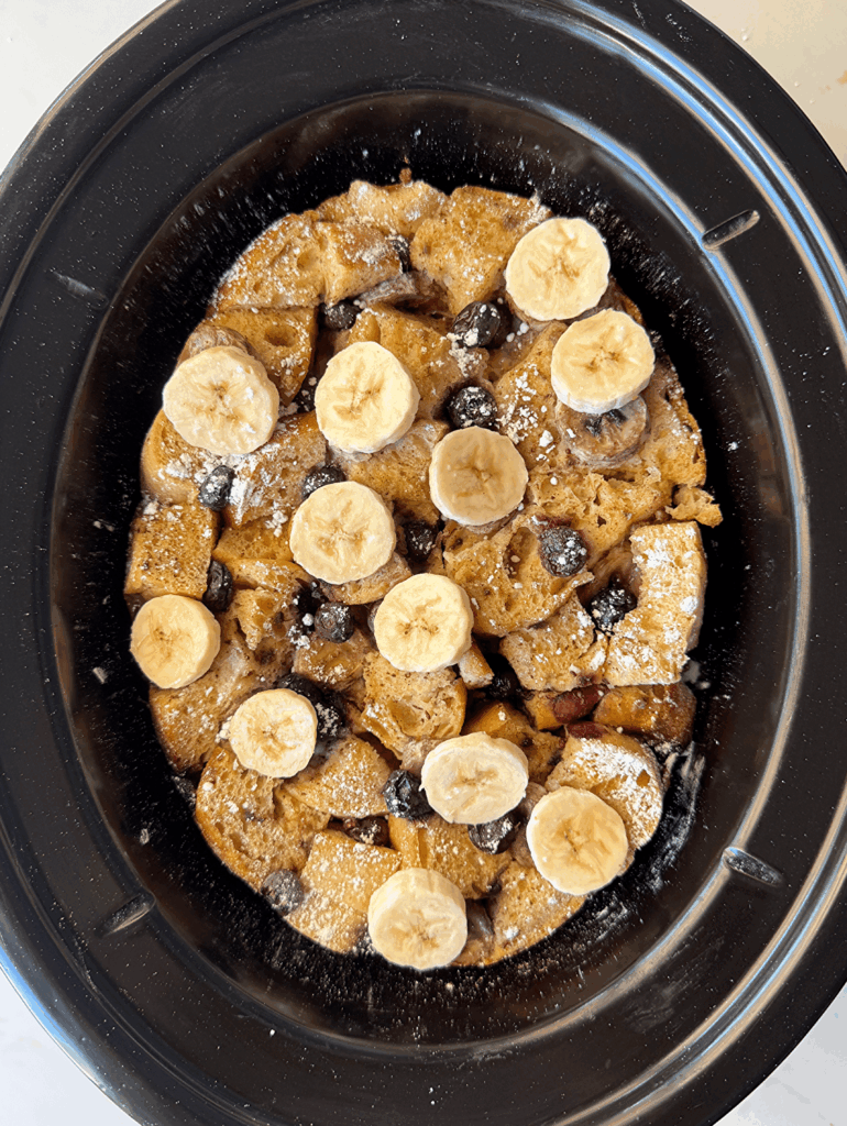 overhead shot of cooked Banana Blueberry French Toast in a black slow cooker