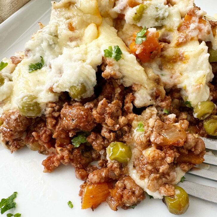 close up shot of cooked Slow Cooker Shepherds Pie on a white plate