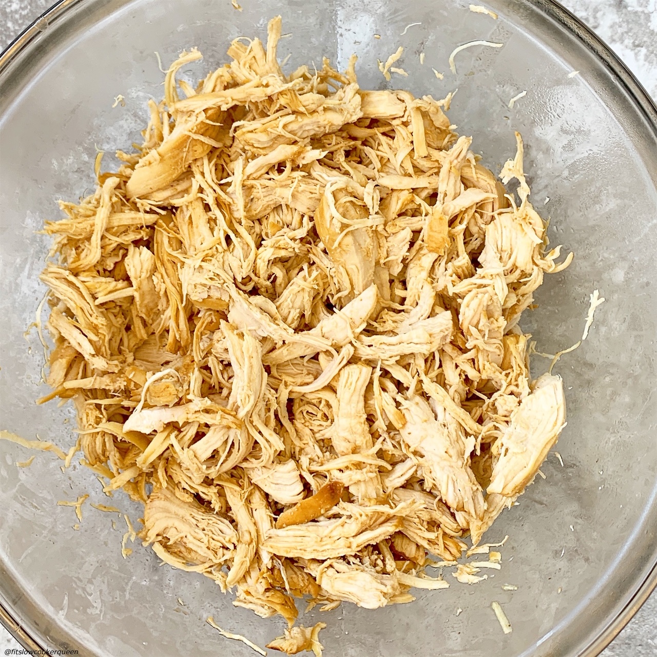 chicken shredded after being cooked in the spicy honey mustard sauce for slow cooker/instant pot spicy honey mustard chicken