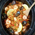 Paella in the slow cooker? Yes! Chicken and seafood are used in this easy and healthy version of paella that cooks in just a couple hours time.