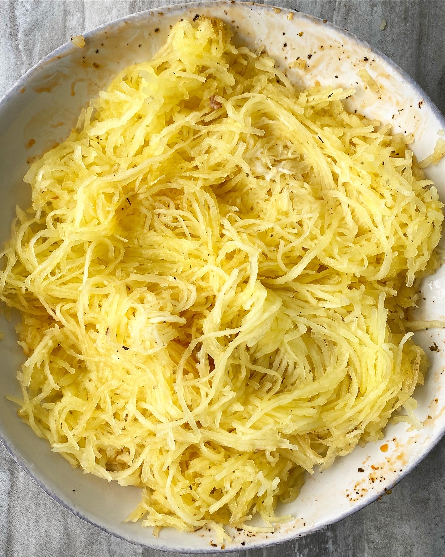 cooked spaghetti squash strands on a white plate