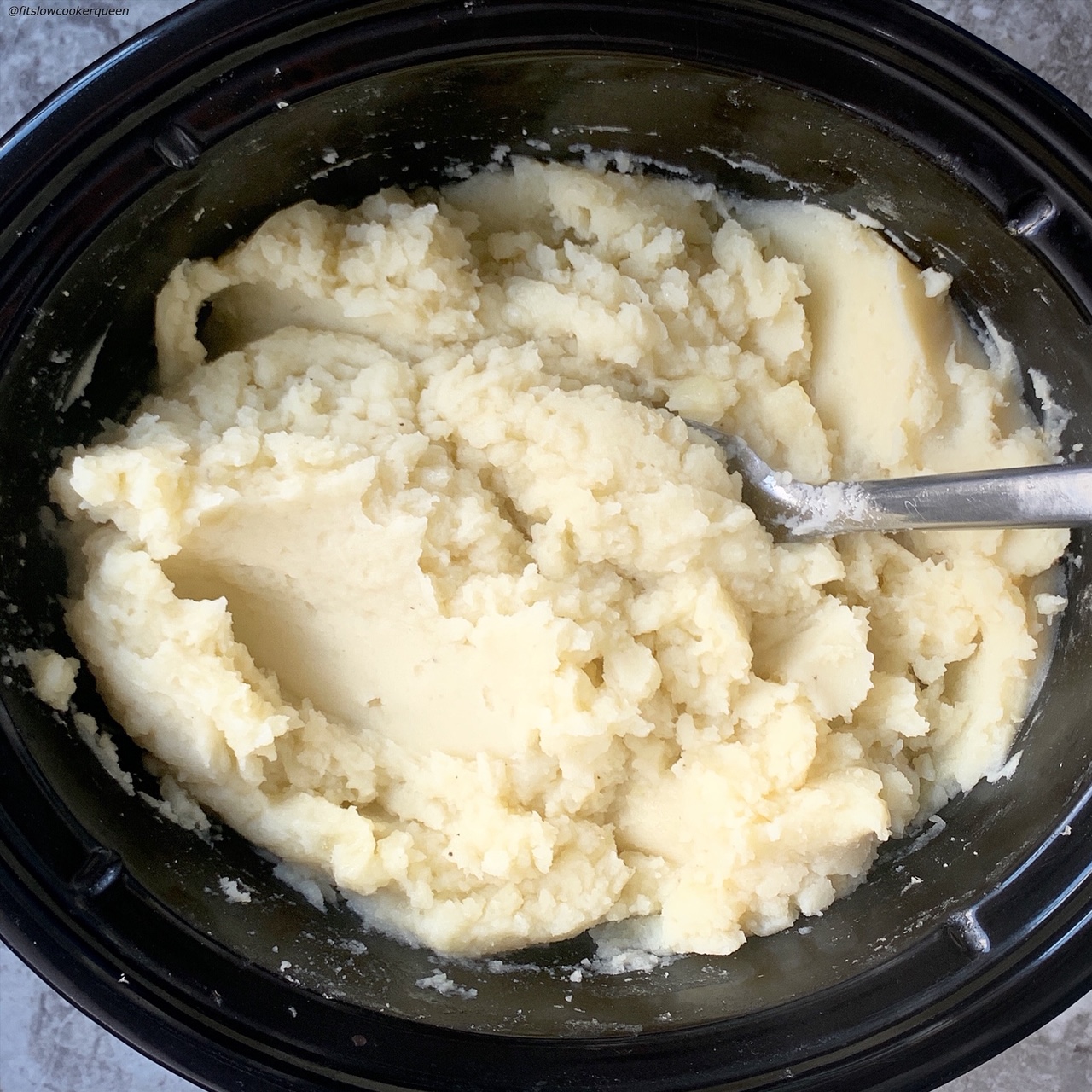 cooked potatoes in the slow cooker that have been mashed