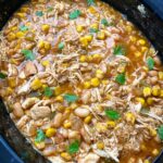 overhead shot of cooked white chicken chili in a black slow cooker