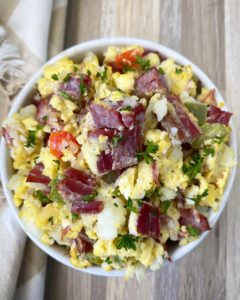 cooked Corned Beef Hash Breakfast Casserole in a white bowl