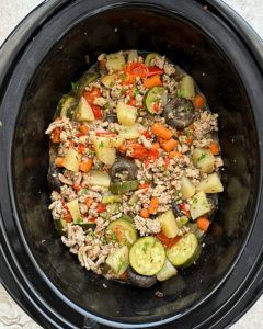 overhead shot of cooked slow cooker ground turkey bowl in a black slow cooker