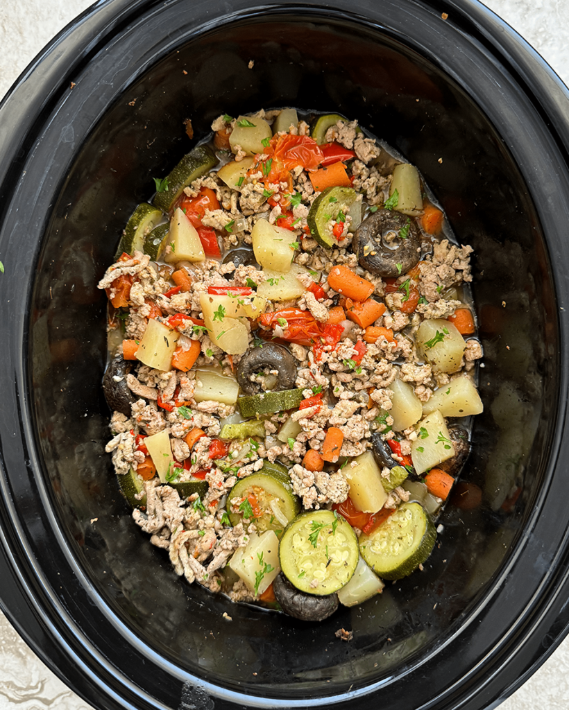 overhead shot of cooked slow cooker ground turkey bowl in a black slow cooker