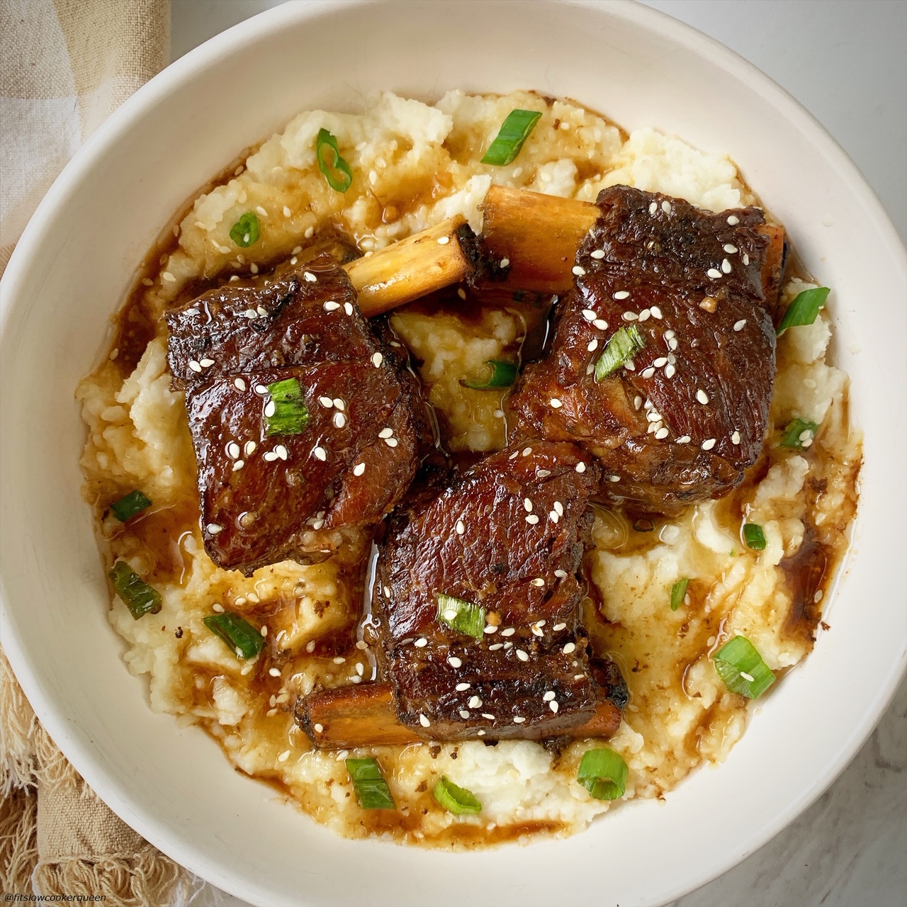 3 plated korean style short ribs served over mashed cauliflower