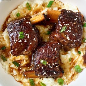 overhead shot of cooked short ribs served over mashed potatoes