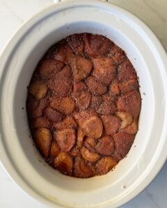 overhead shot of cooked strawberry basil jam in a white slow cooker