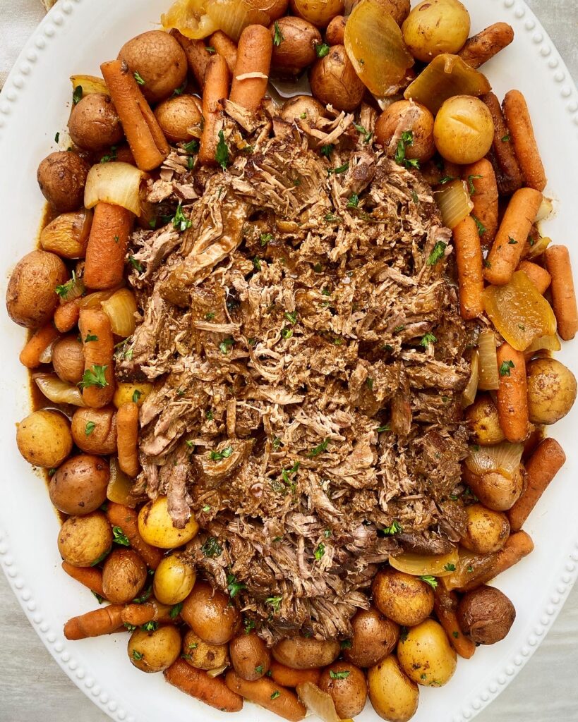 overhead shot of up of balsamic Dijon pot roast on a white serving platter