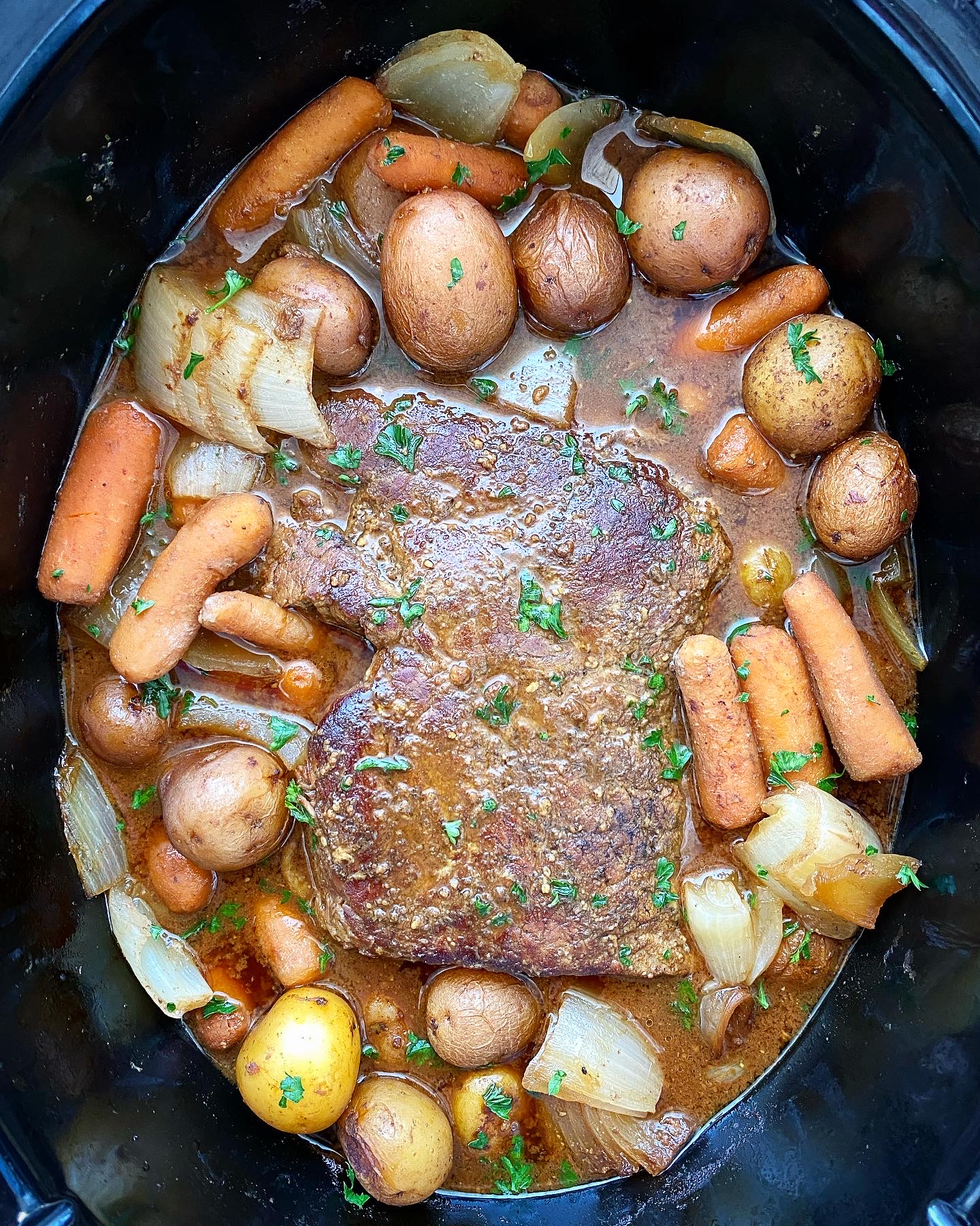 cooked pot roast ingredients in the slow cooker