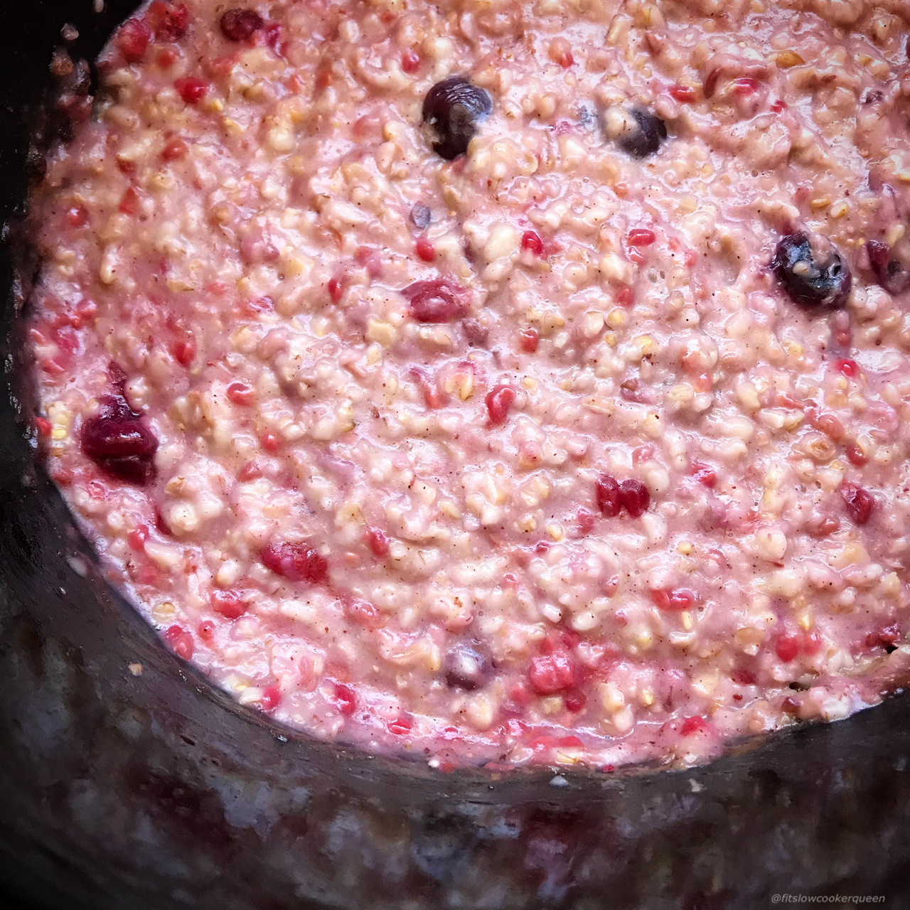 berry oatmeal in a black slow cooker