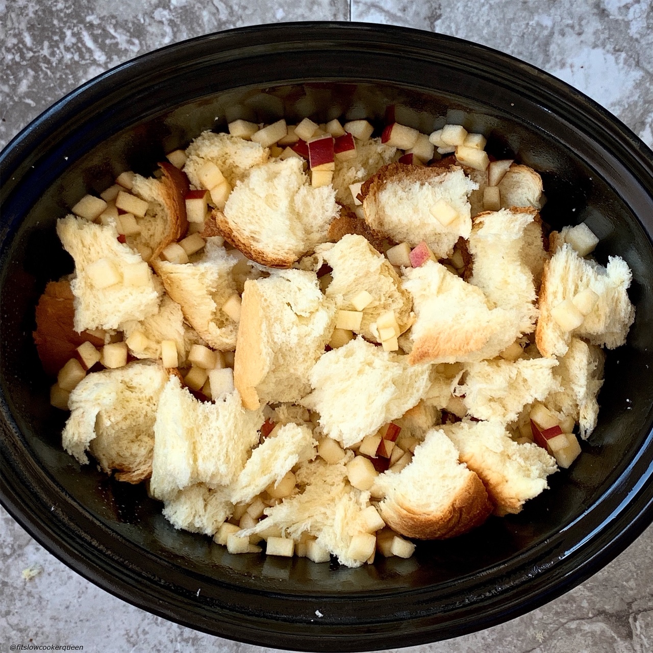 challah and diced apples in the slow cooker for Slow Cooker Apples & Honey Challah Bread Pudding 
