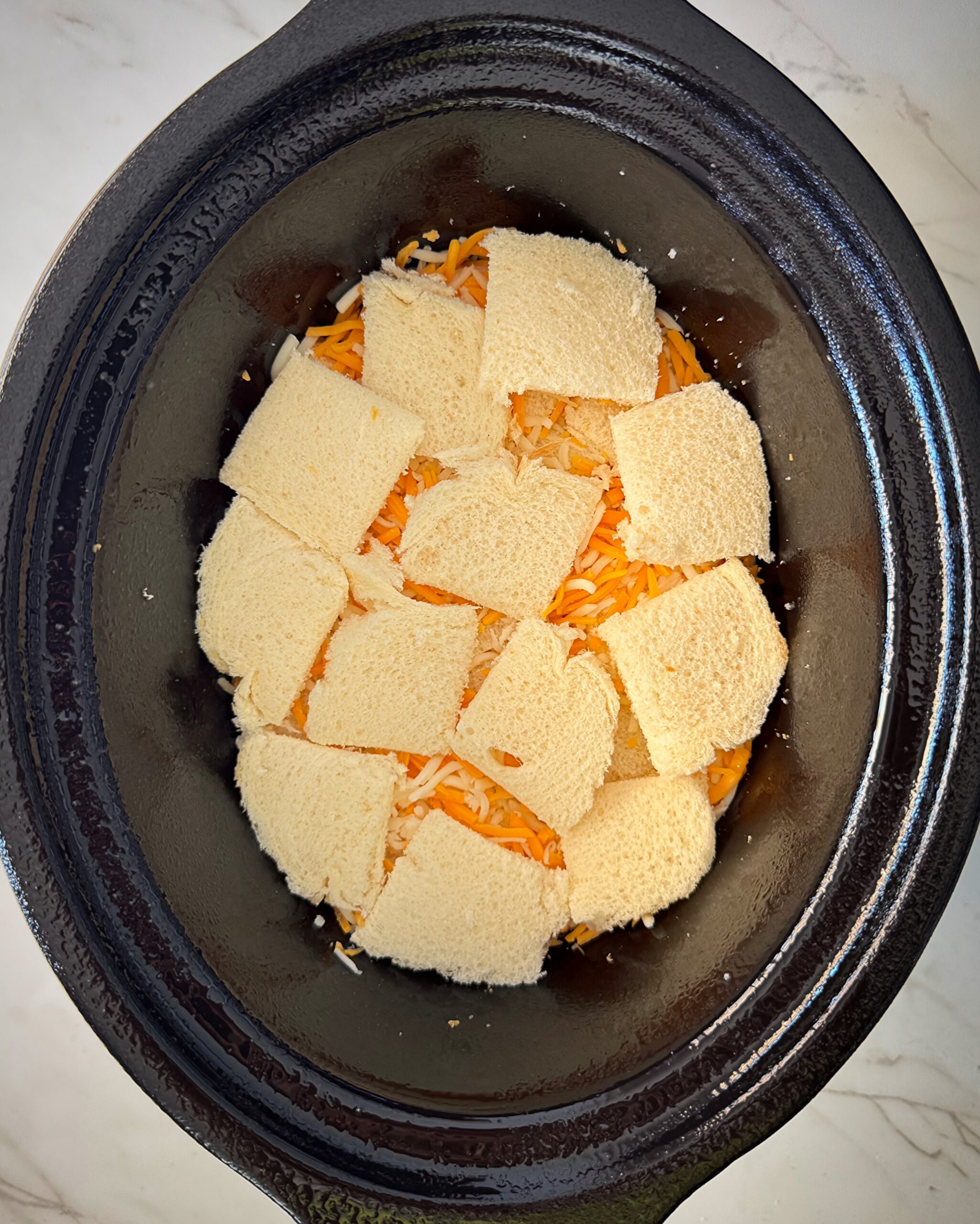 overhead shot of cooked overhead of Cheese Souffle in a black slow cooker