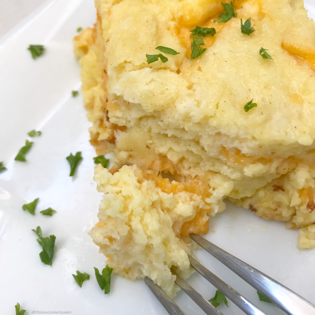 overhead of Cheese Souffle on a white plate garnished with fresh parsley