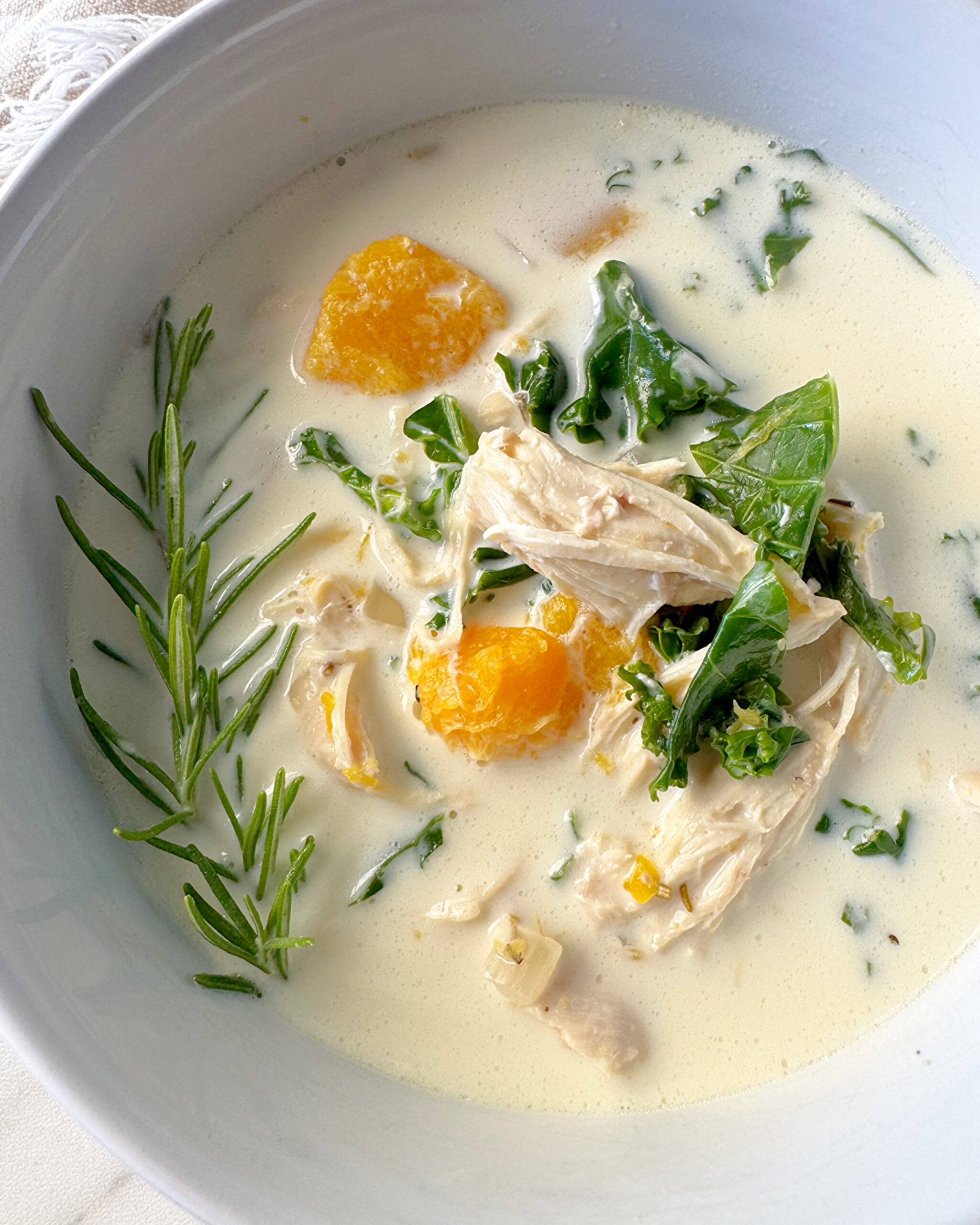 overhead, close up shot of Crockpot Chicken Butternut Squash Soup in a white bowl