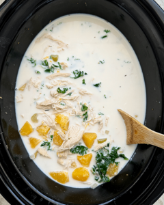overhead shot of cooked Crockpot Chicken Butternut Squash Soup in a black slow cooker