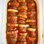 layered, cooked kofta patties, potatoes, and tomatoes in the slow cooker with tomato sauce on top