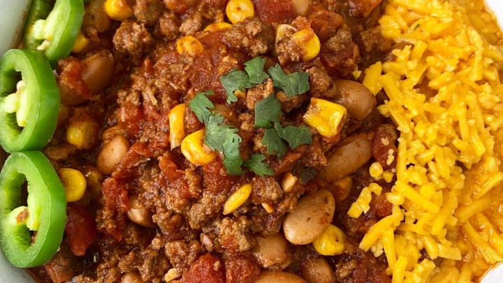 close up of overhead shot of taco chili in a white bowl with a jalapeno with cheese