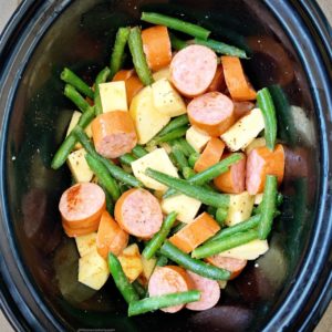 Sausage, potatoes, and green beans cook together in this simple slow cooker or Instant Pot staple recipe. Both paleo, and whole30, this healthy recipe can be served any time of the week. 