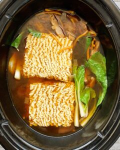overhead shot of cooked soup with in a black slow cooker