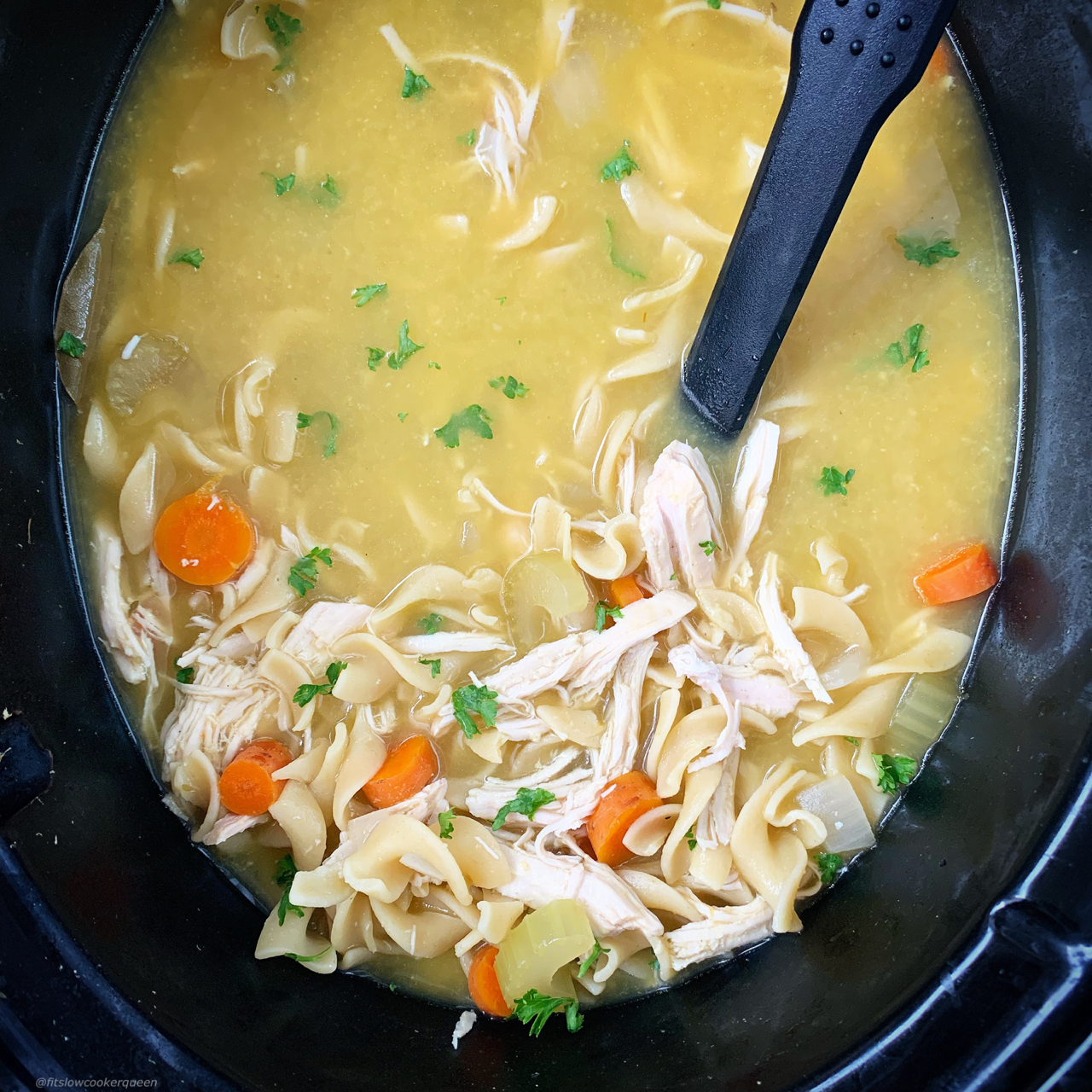 after pic of cooked chicken noodle soup in the slow cooker