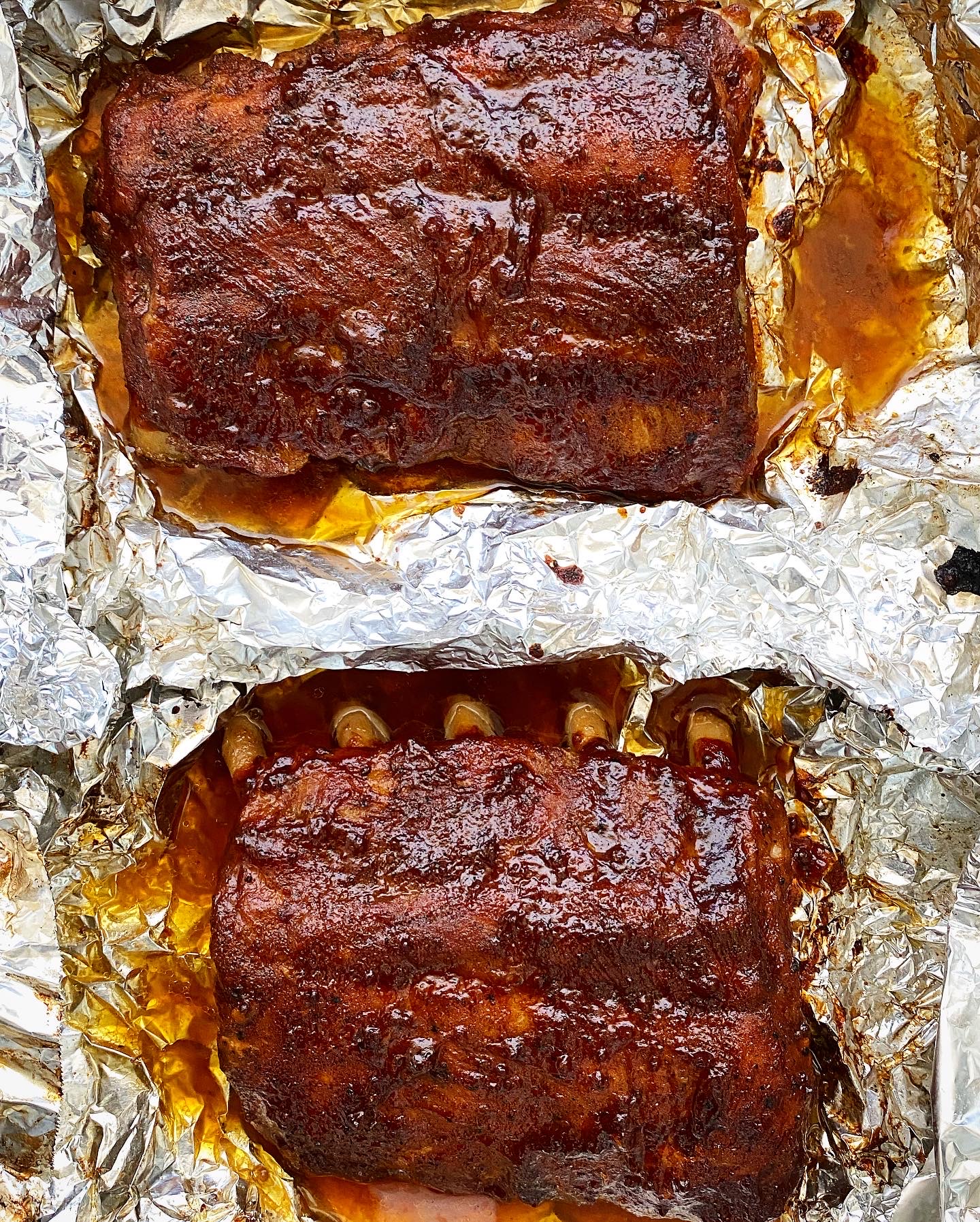 broiled ribs with bbq sauce on foil