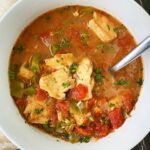 overhead shot of Slow Cooker Mediterranean Fish Stew in a white bowl