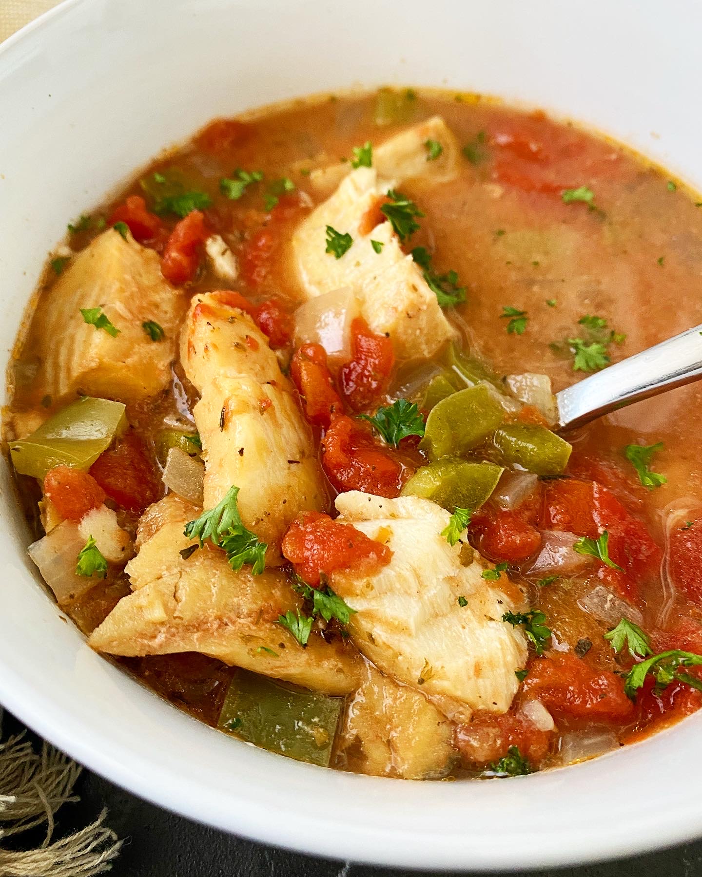 overhead shot of Slow Cooker Mediterranean Fish Stew in a white bowl