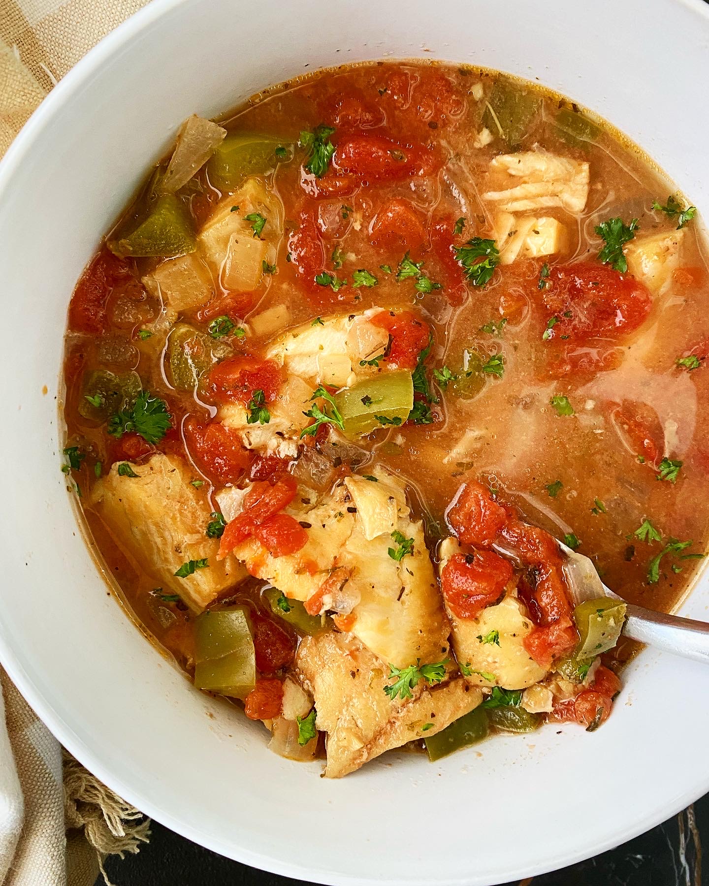 overhead shot of Slow Cooker Mediterranean Fish Stew in a white bowl