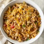 overhead shot of spicy turkey slaw in a white bowl