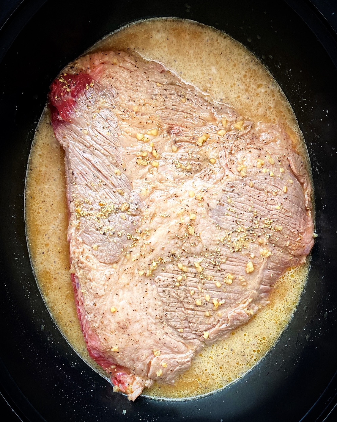 raw brisket in the slow cooker
