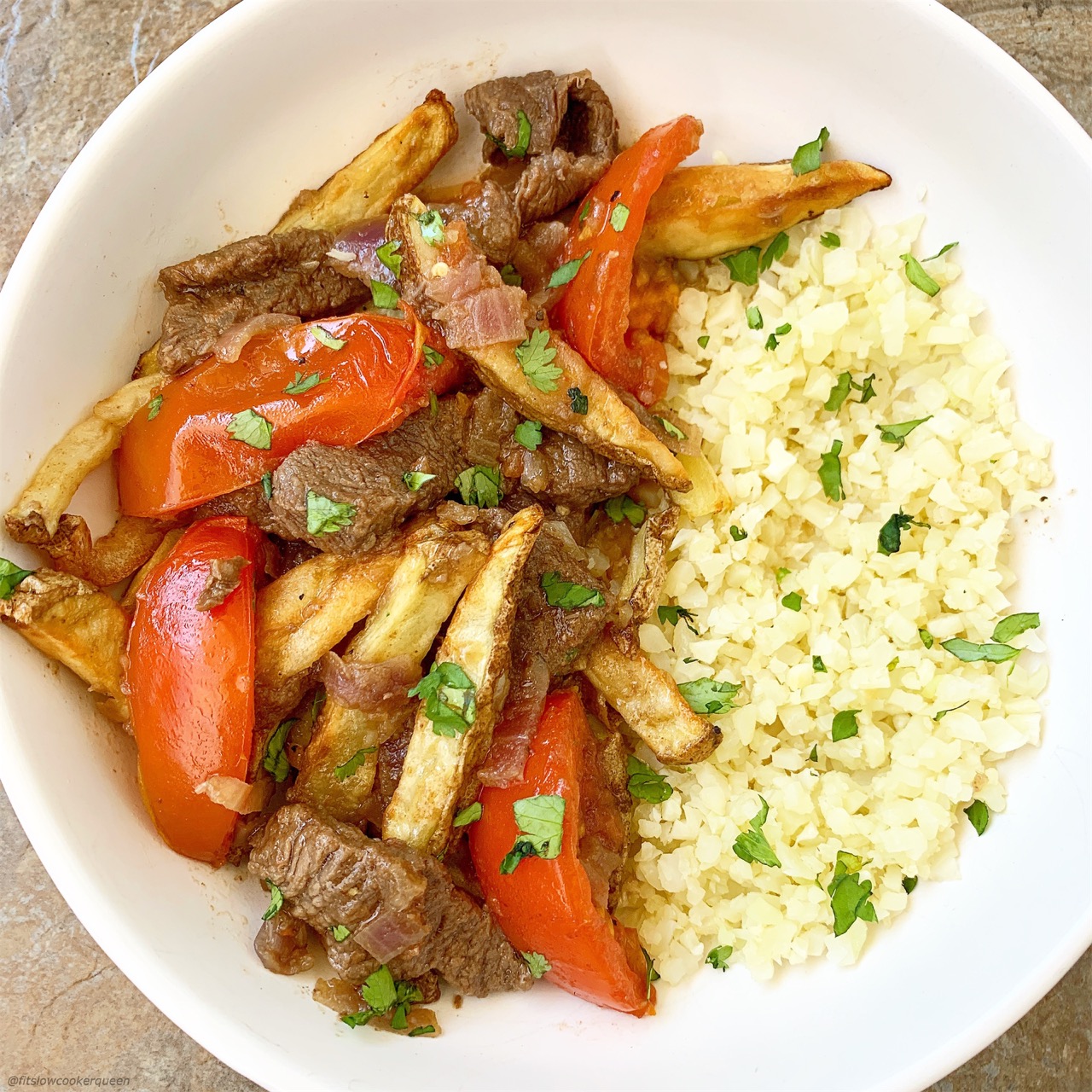 Lomo saltado is Peruvian dish that combines beef stir-fry, french fries and rice. Make this paleo/whole30 version in your slow cooker or Instant Pot.