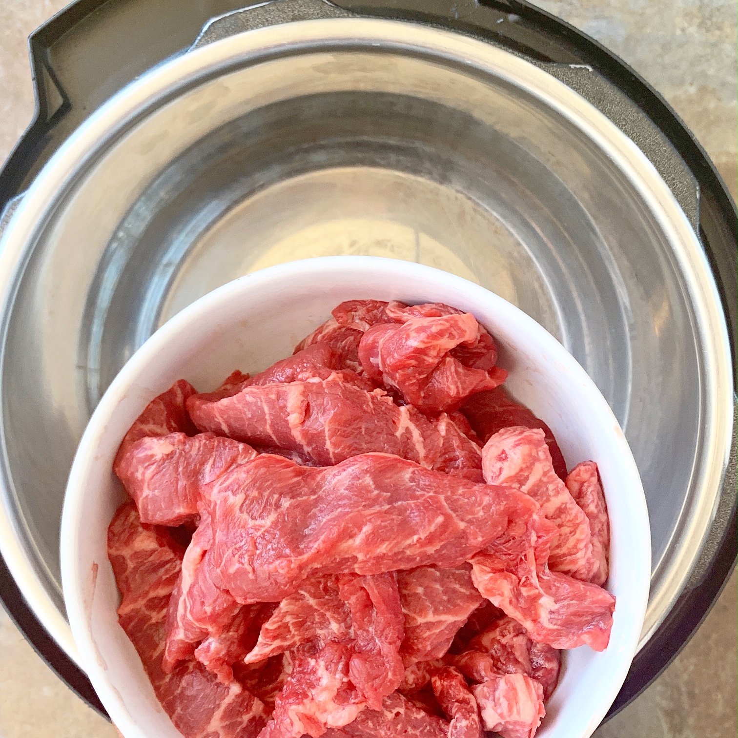 Lomo saltado is Peruvian dish that combines beef stir-fry, french fries and rice. Make this paleo/whole30 version in your slow cooker or Instant Pot.